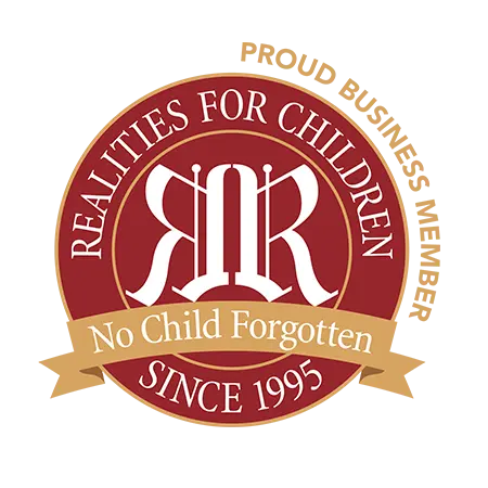 Logo for Realities for Children with text 'Proud Business Member', 'No Child Forgotten', and 'SINCE 1995'.